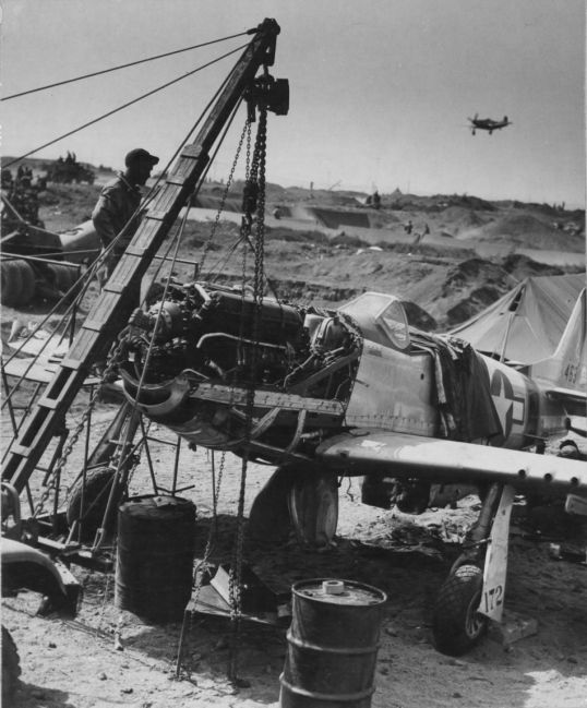 A mobile repair unit of a 7th Fighter Command Service Group repairs a P-51