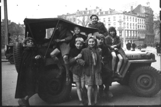 Belgian children posed on an American jeep