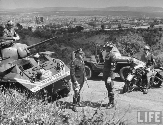 Soldiers standing on path and talking.